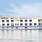 The elegant H/S Sindbad Nile Cruise sails smoothly along the majestic river, a symbol of luxury travel and adventure in Egypt.