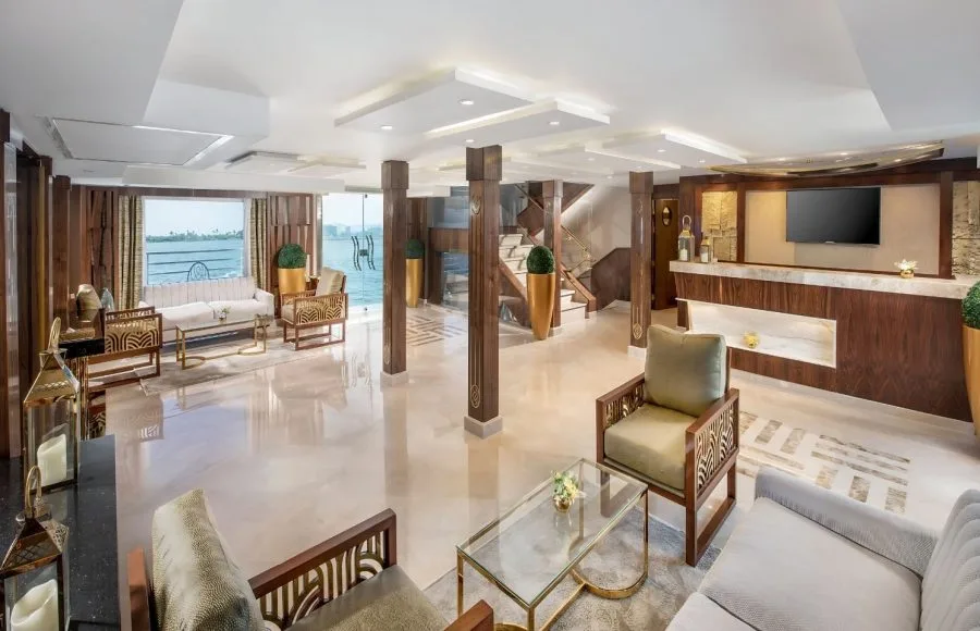 The elegant and spacious reception lounge of the Sindbad Nile Cruise, featuring stylish seating, modern decor, and stunning river views from large windows.