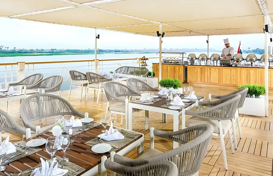 An elegant outdoor dining area on the Sindbad Nile cruise, offering delicious meals with stunning panoramic views of the river.
