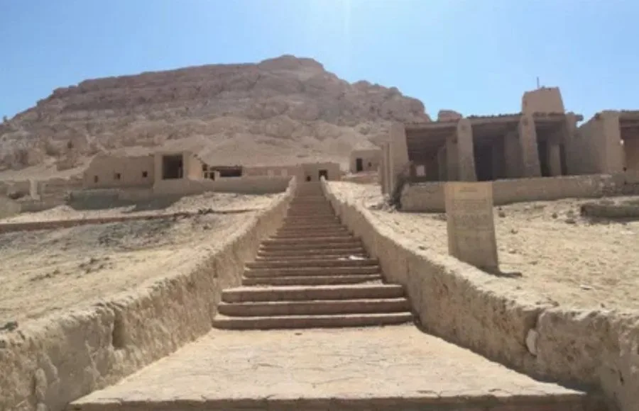 A long, upward-sloping set of stone Stairs and a pathway leading to buildings on the lower slopes of the sandy Siwa Dakrour Mountains in Egypt.