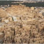 An Aerial View of the densely packed, crumbling mud-brick houses and Ruins of The Old City of Siwa, built on a rocky outcrop in the Siwa Oasis, Egypt.