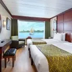 Kon Tiki Nile cruise twin cabin with a large window and twin beds overlooking the river.