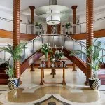 Elegant lobby of the Kon Tiki Nile cruise with potted plants and a reception area.