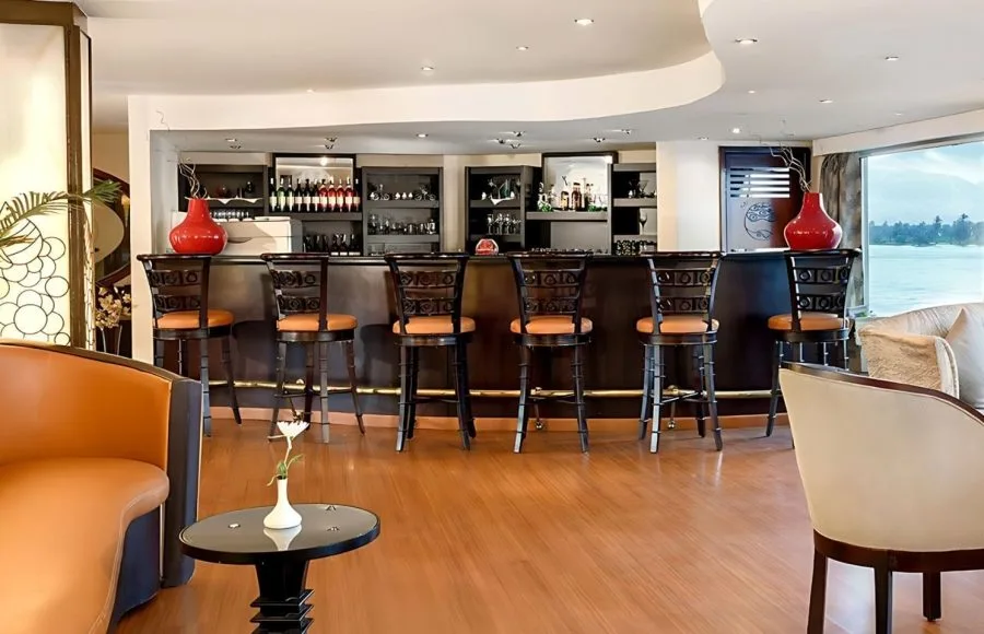 Kon Tiki Nile cruise bar and lounge with a view of the river, modern seating, and a fully stocked bar.