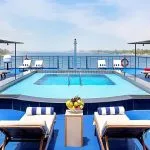 The refreshing swimming pool and sun deck on the Kon Tiki Nile cruise with loungers and panoramic river views.