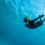 A-female-free-diver-diving-down-below-the-water’s-surface-in-the-red-sea-near-Hurghada