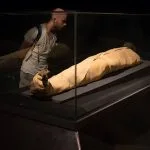 A-male-tourist-examines-the-mummy-of-Ramses-I-inside-the-Luxor-Museum-in-Luxor