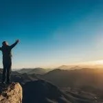 A-man-stands-facing-the-rising-sun-on-Mount-Sinai