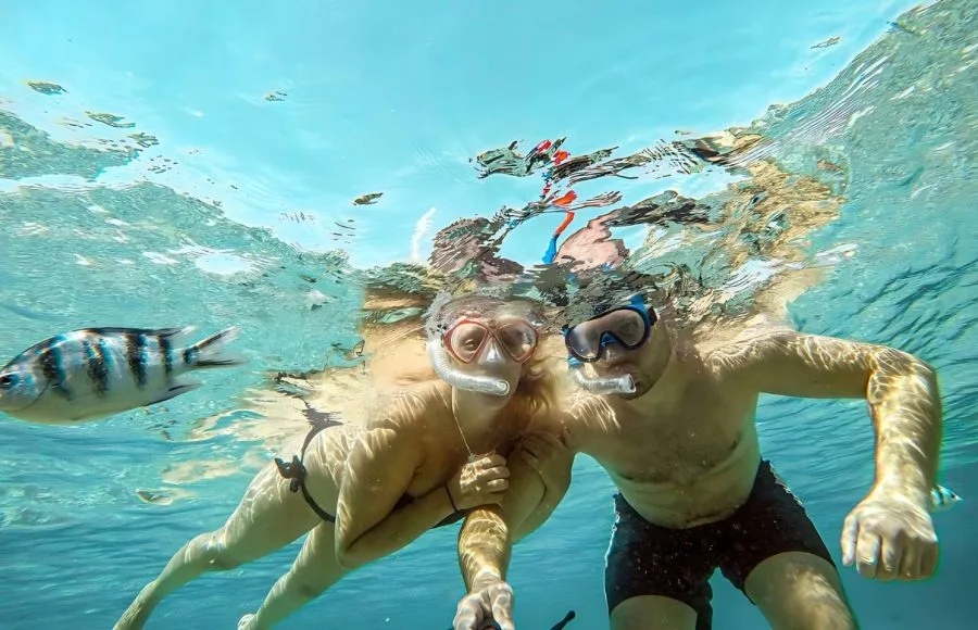 A-young-couple-is-snorkeling-selfie-with-an-underwater-camera-on-the-coral-reef-in-Hurghada