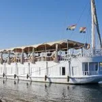 A side view of the traditional Abundance Dahabiya sailboat on the Nile River.