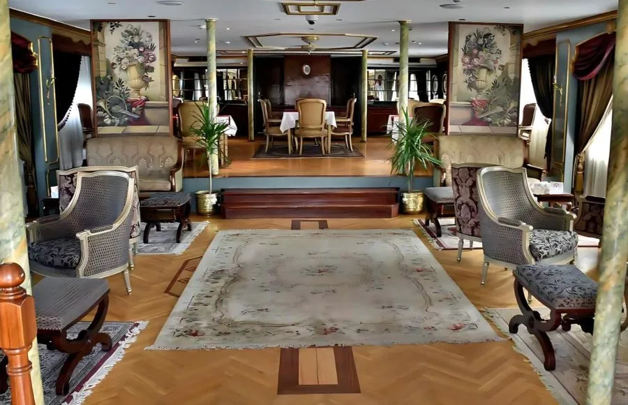 Interior lounge of a Rois Dahabiya Nile Cruise boat with traditional oriental furniture.