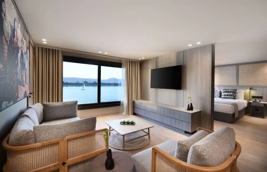 A luxury hotel room suite on a Nile cruise ship with a river view.