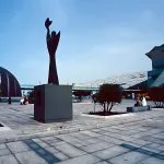 Modern sculpture and the distinct, sloping architecture of the Bibliotheca Alexandrina in Alexandria.