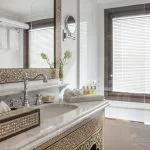 Bathroom with marble counter, sink, bathtub, and patterned decor on a Nile cruise ship.