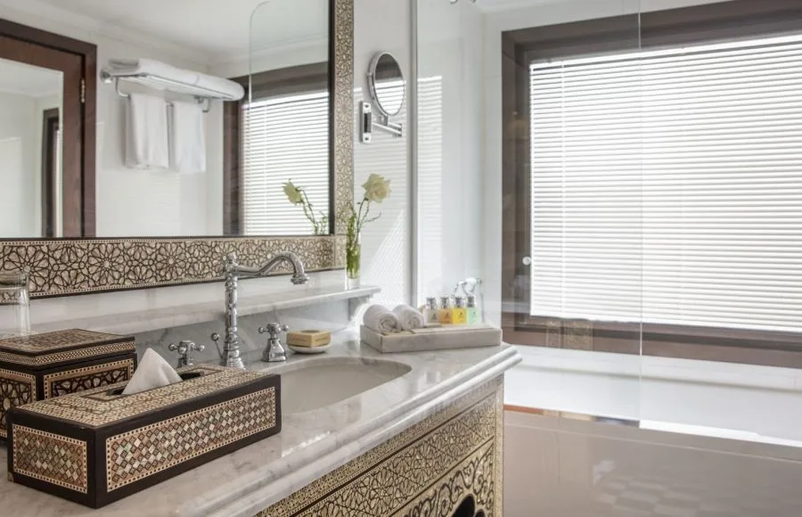Bathroom with marble counter, sink, bathtub, and patterned decor on a Nile cruise ship.