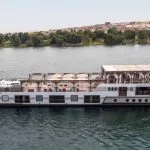 Traditional two-masted Dahabiya Nile cruise boat sailing on the river.