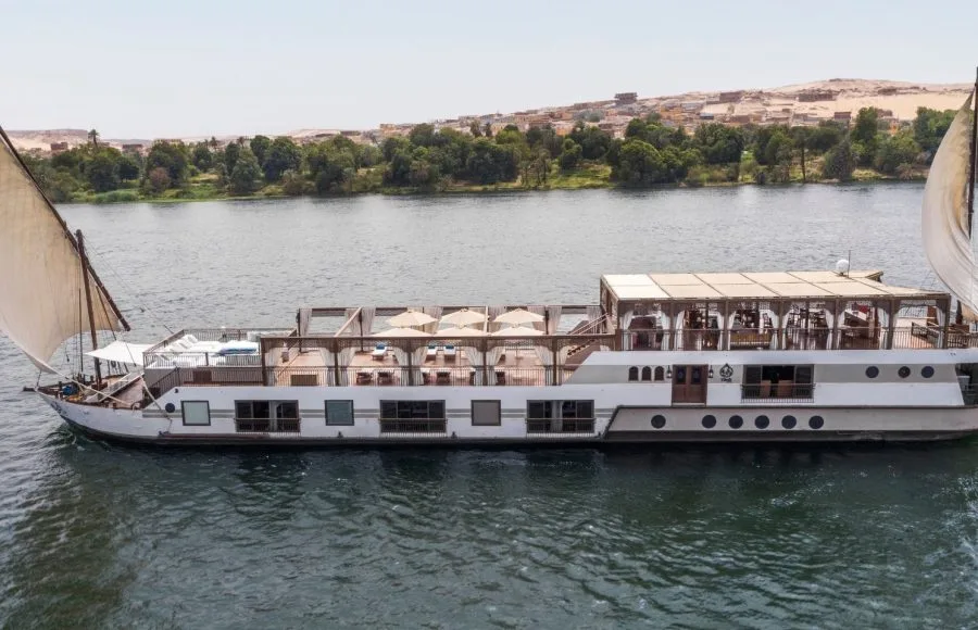 Traditional two-masted Dahabiya Nile cruise boat sailing on the river.