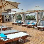 Jaz Yakouta Dahabiya Nile Cruise sun deck with lounge chairs and umbrellas.