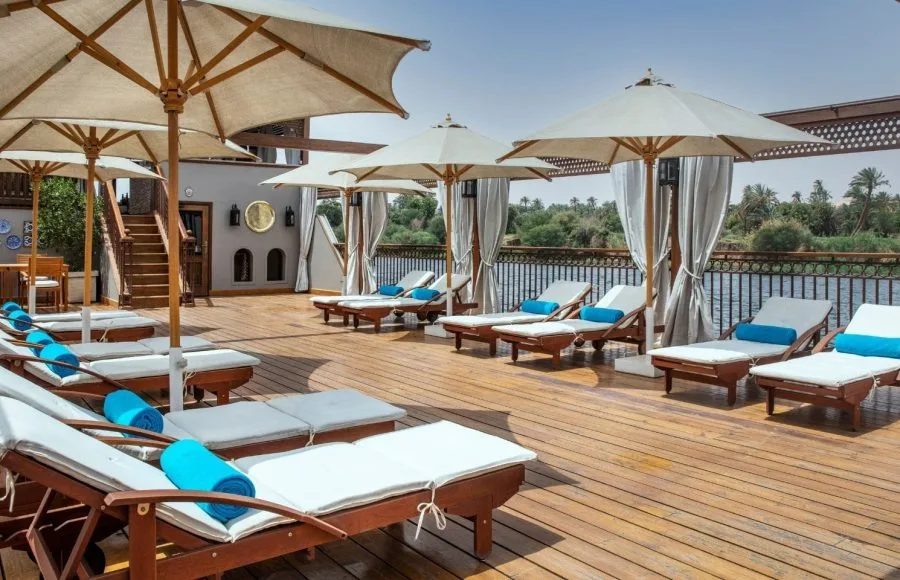 Jaz Yakouta Dahabiya Nile Cruise sun deck with lounge chairs and umbrellas.