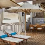 A relaxing sun deck view on the Jaz Yakouta Dahabiya Nile Cruise, featuring lounge chairs and umbrellas.