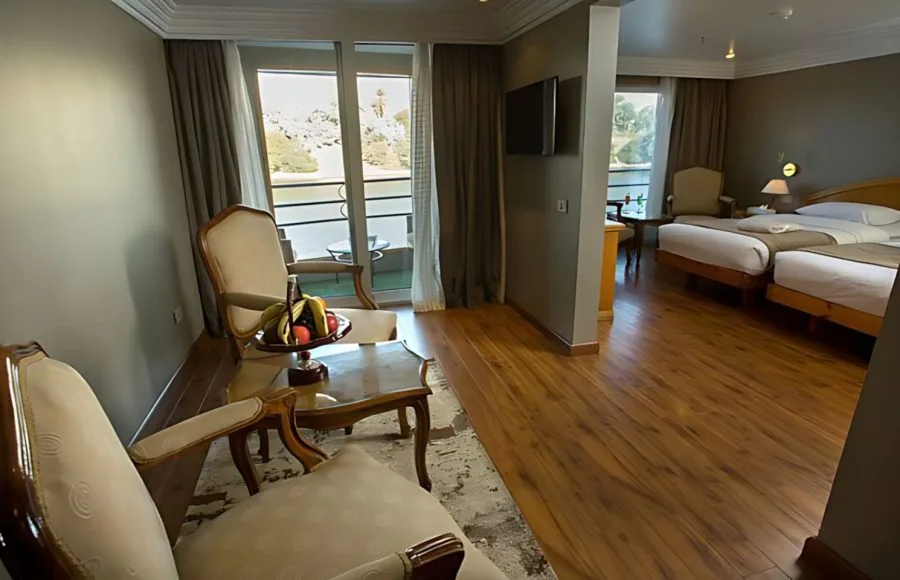 A cozy twin bed cabin on the MS A Sara, featuring comfortable beds and a window with a view of the Nile.