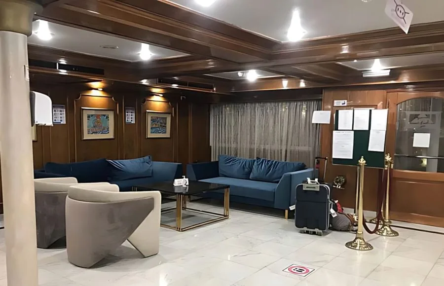 The A Sara Nile Cruise lobby features cozy blue sofas and modern chairs, offering a relaxing lounge space.