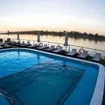 A swimming pool on the sun deck of the MS A Sara, surrounded by lounge chairs.
