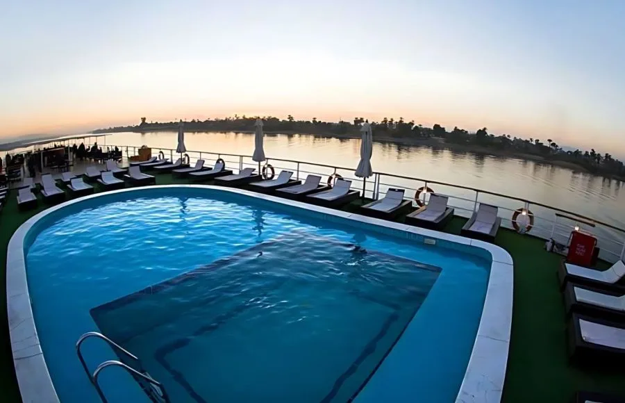 A swimming pool on the sun deck of the MS A Sara, surrounded by lounge chairs.