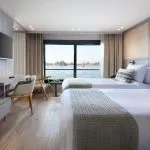 Hotel room with twin beds and a view of the water.