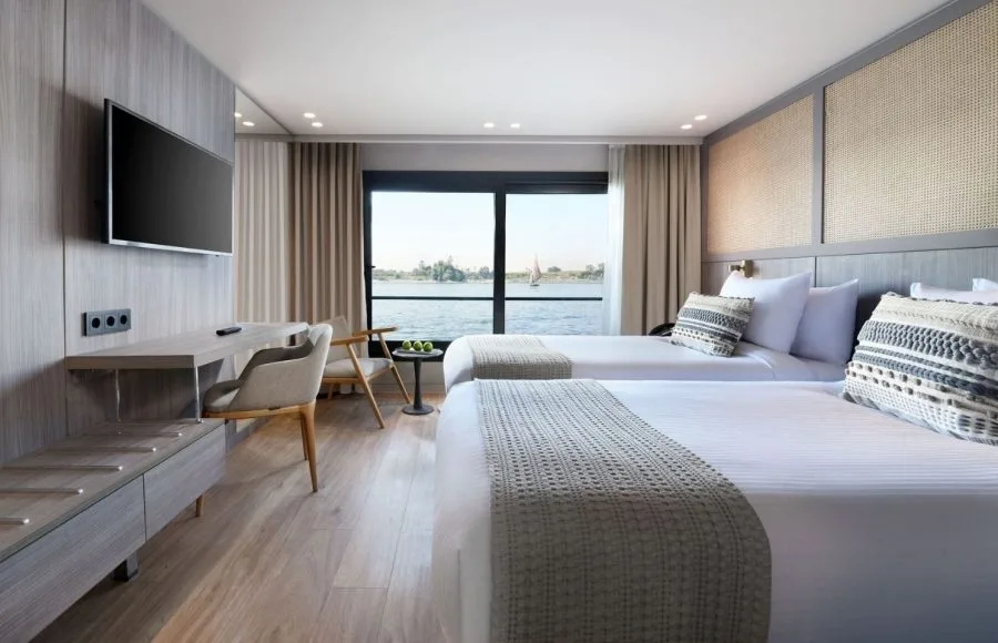 Hotel room with twin beds and a view of the water.