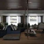 Modern luxury yacht or suite interior with seating and a panoramic window view.