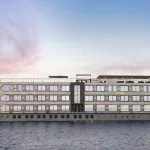 A modern, multi-deck river cruise ship named Historia The Boutique Hotel Nile Cruise on the water.