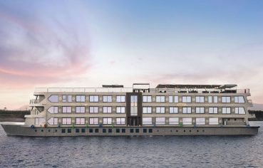A modern, multi-deck river cruise ship named Historia The Boutique Hotel Nile Cruise on the water.
