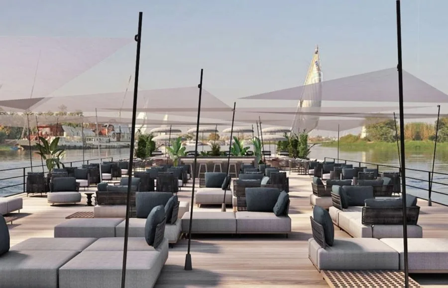 The rooftop pool area with lounge chairs and umbrellas.