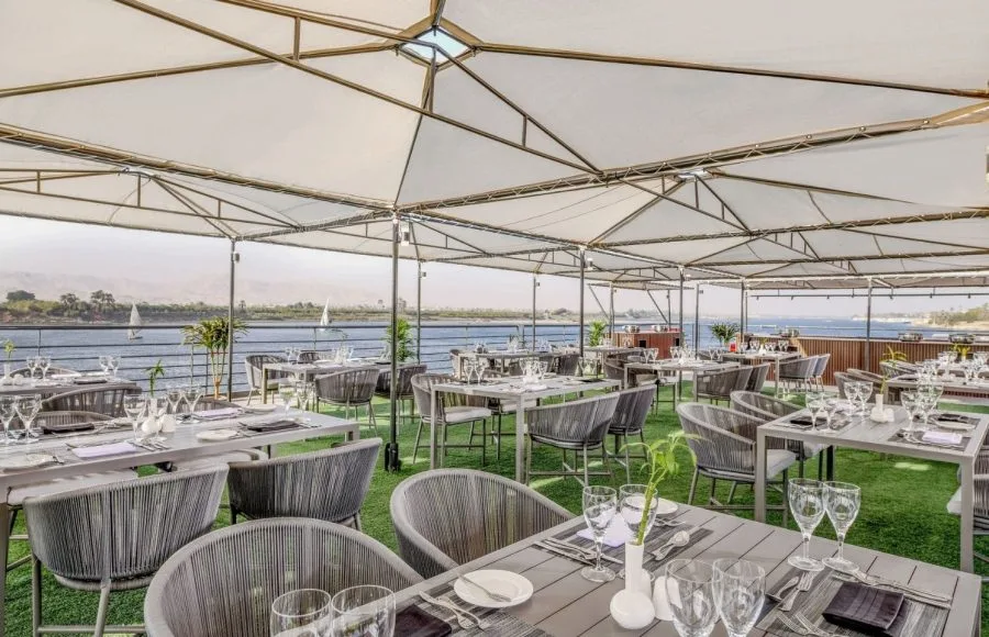 Sundeck dining area on the Historia Nile Cruise ship with views of the river.