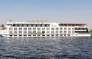 The MS Jaz Viceroy Nile Cruise ship sailing on the Nile River, with its white exterior and multiple decks visible against the calm water and clear sky.