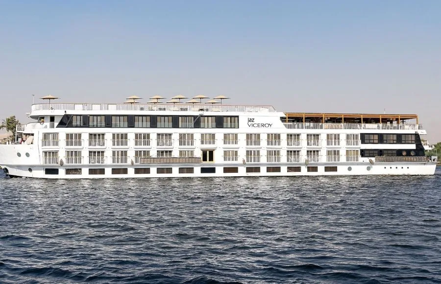 The MS Jaz Viceroy Nile Cruise ship sailing on the Nile River, with its white exterior and multiple decks visible against the calm water and clear sky.