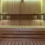 The interior of a clean and modern sauna room on the Jaz Viceroy Nile Cruise, made with light-colored wooden panels.