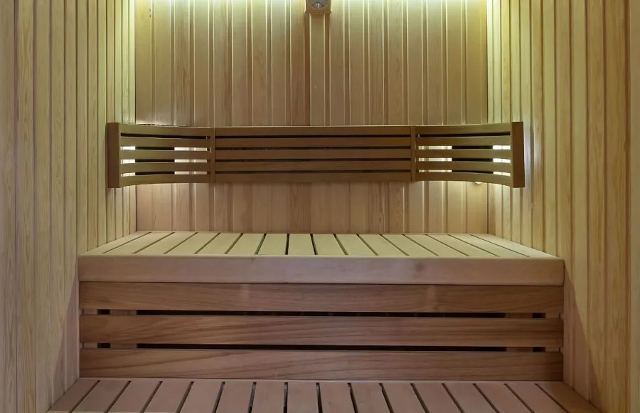 The interior of a clean and modern sauna room on the Jaz Viceroy Nile Cruise, made with light-colored wooden panels.