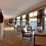 Elegant lounge bar with floor-to-ceiling windows overlooking the Nile on the Oberoi Philae.