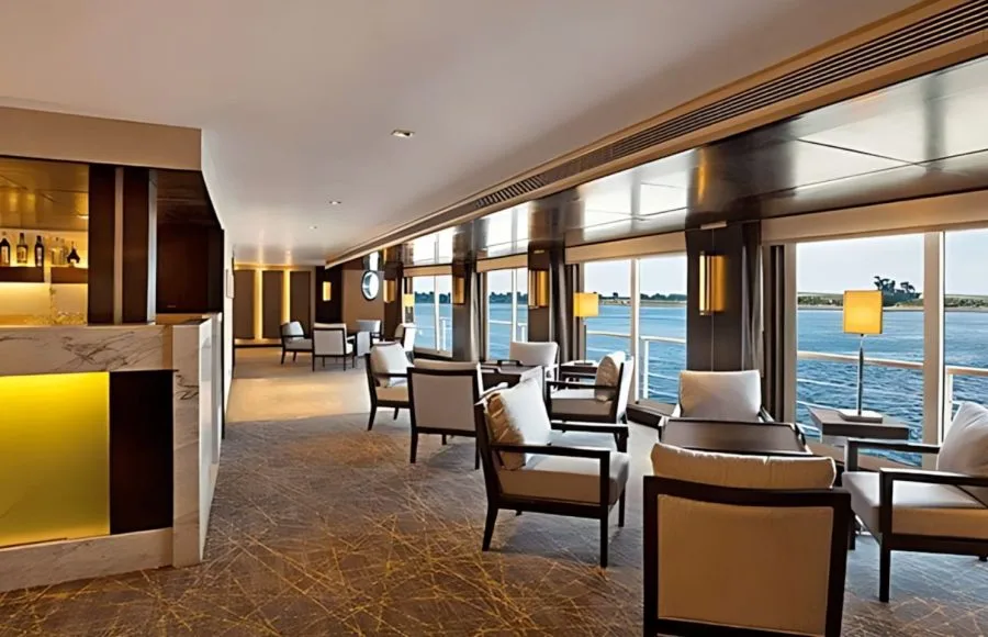 Elegant lounge bar with floor-to-ceiling windows overlooking the Nile on the Oberoi Philae.