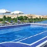 Swimming pool with sun loungers on the Oberoi Philae Luxury Nile Cruise.