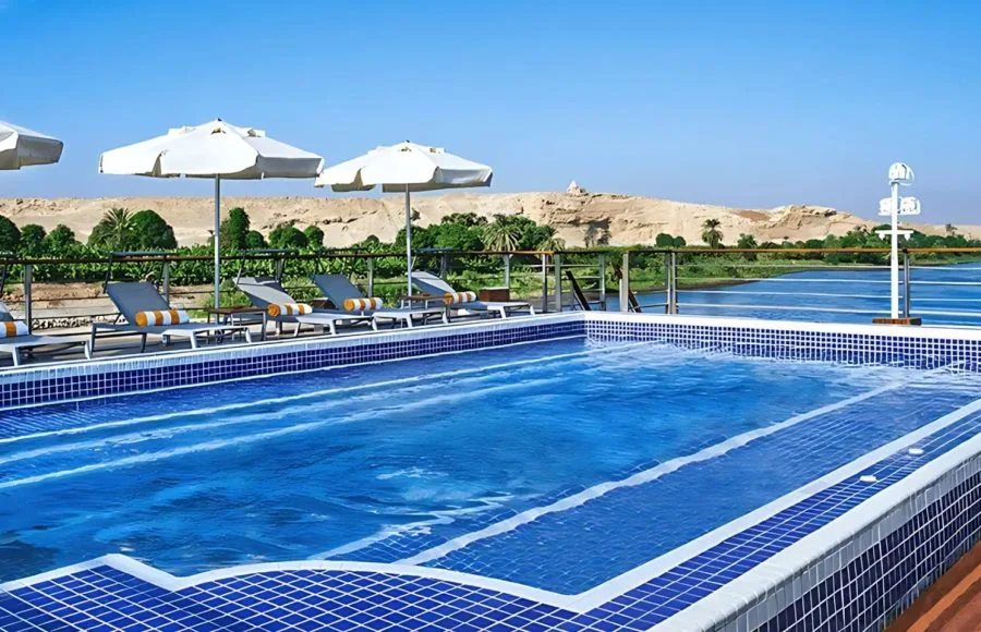 Swimming pool with sun loungers on the Oberoi Philae Luxury Nile Cruise.