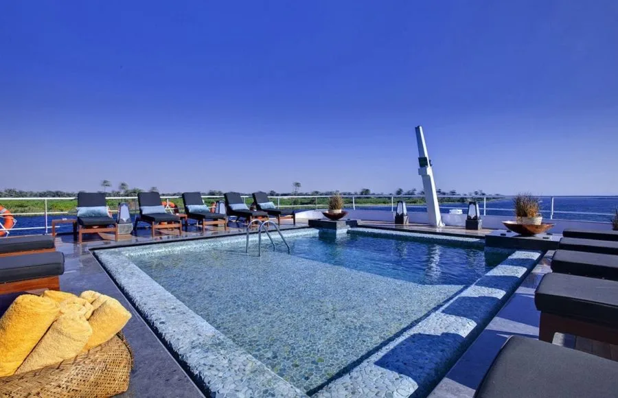Clear swimming pool and sun loungers on the deck of the MS Sanctuary Nile Adventurer.
