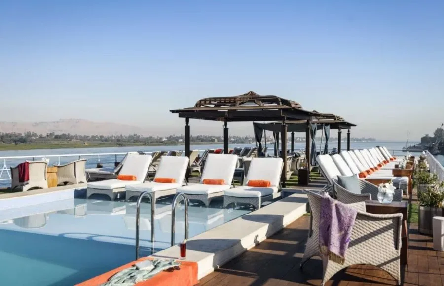 Sun deck with a small pool, comfortable loungers, and shaded seating on the Sanctuary Sun Boat IV Nile Cruise.