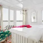 Bright luxury suite with panoramic river views on a Dahabiya Nile cruise.