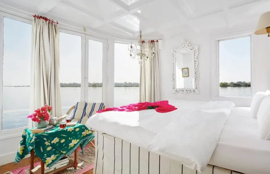 Bright luxury suite with panoramic river views on a Dahabiya Nile cruise.