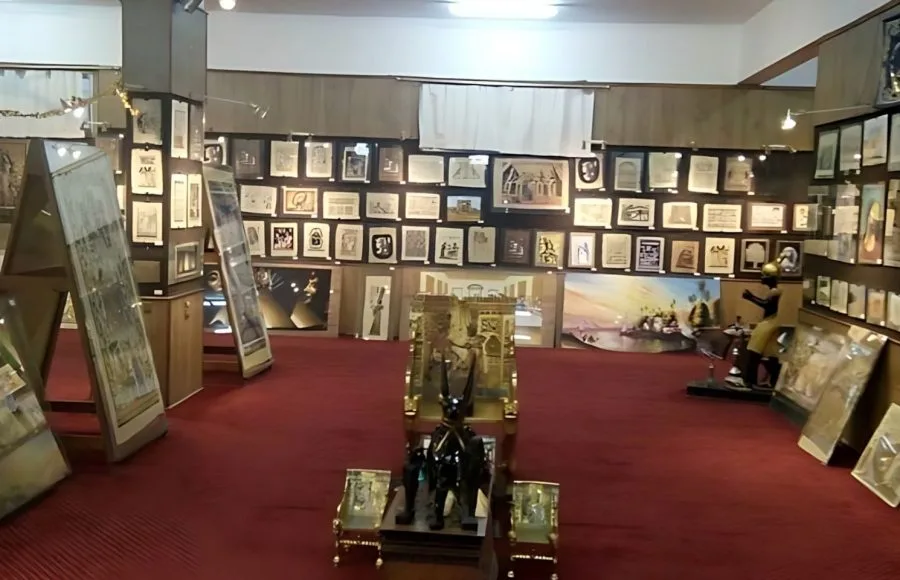 Interior view of the Egypt Papyrus Institute gallery showcasing framed papyrus paintings and statues.