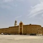 Massive fortified walls and bell tower of Saint Macarius Monastery in Wadi El Natrun, Egypt.