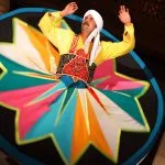 Close-up of a Tanoura dancer's vibrant star-patterned skirt in mid-spin.
